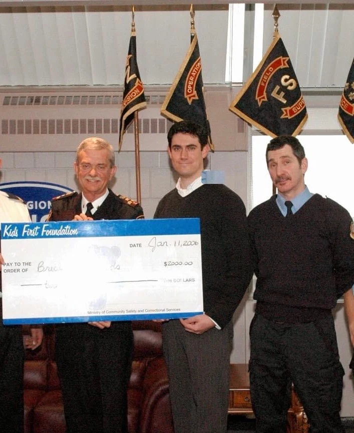 Mike Foley helping present a Kids First Foundation fundraising cheque
