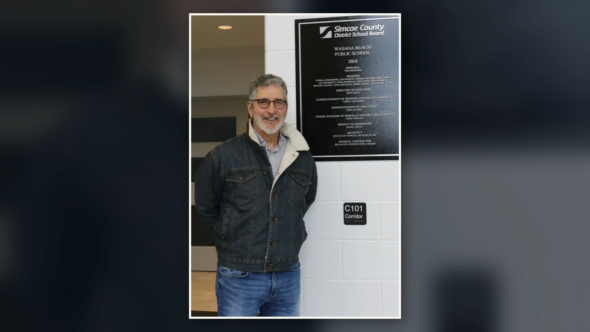 Mike Foley beside the Wasaga Beach Public School opening plaque